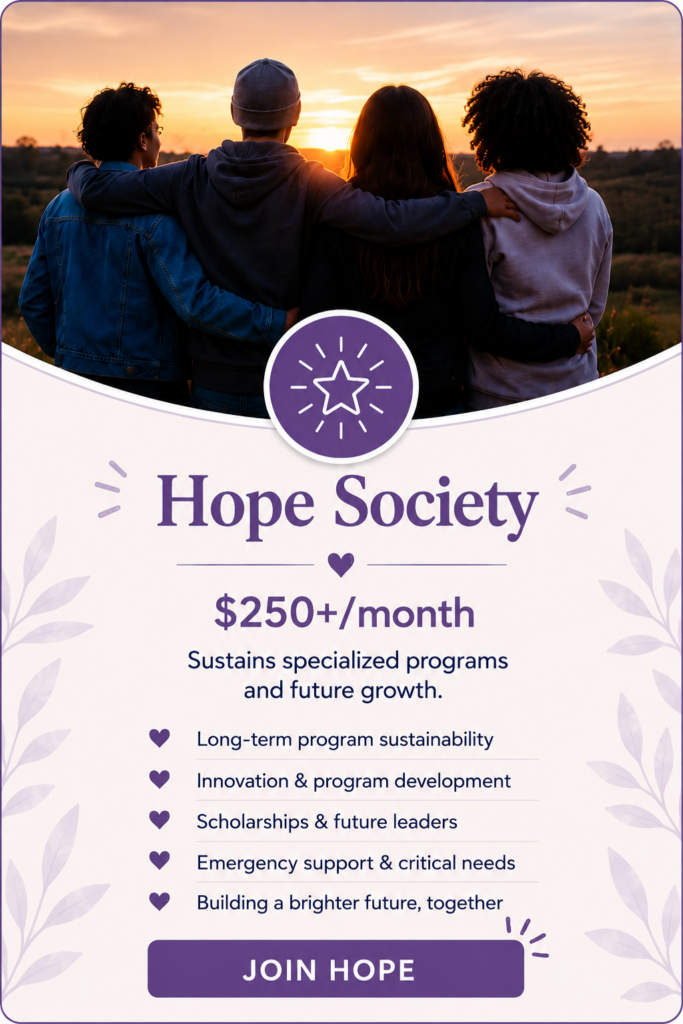 A group of young people stand together with arms around each other at sunset, representing the Hope Society and the long-term support that helps build brighter futures for youth and families.